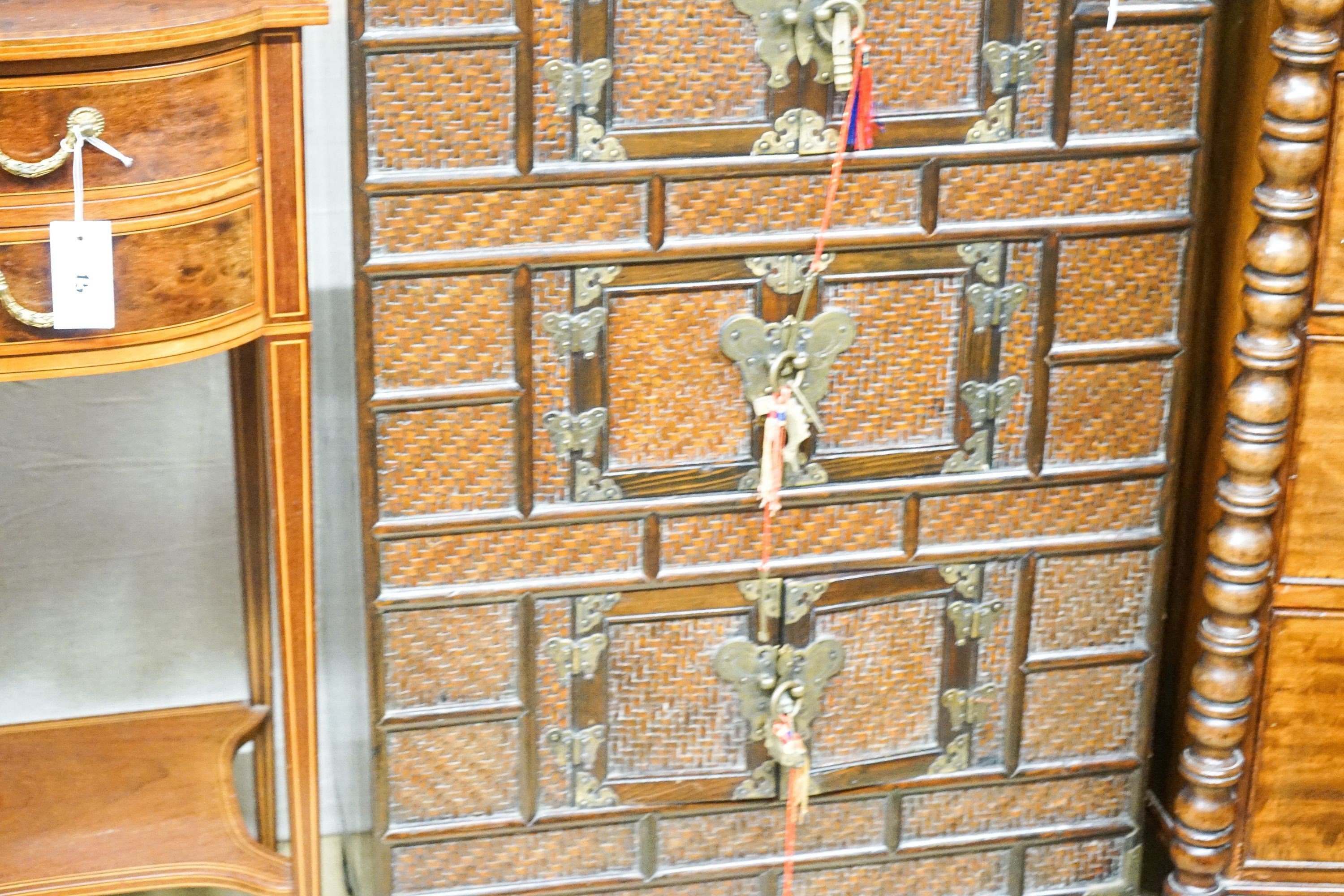 A 20th century Chinese stained wood and rattan side cabinet, width 67cm, depth 32cm, height 104cm